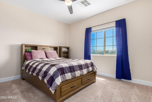 carpeted bedroom with visible vents, baseboards, and ceiling fan