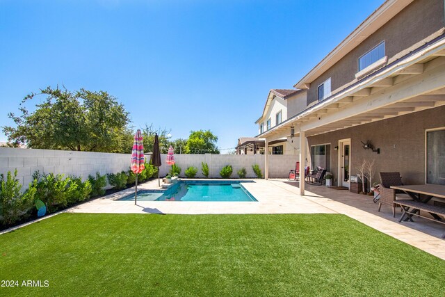 view of swimming pool with a fenced backyard, a fenced in pool, a patio, and a yard