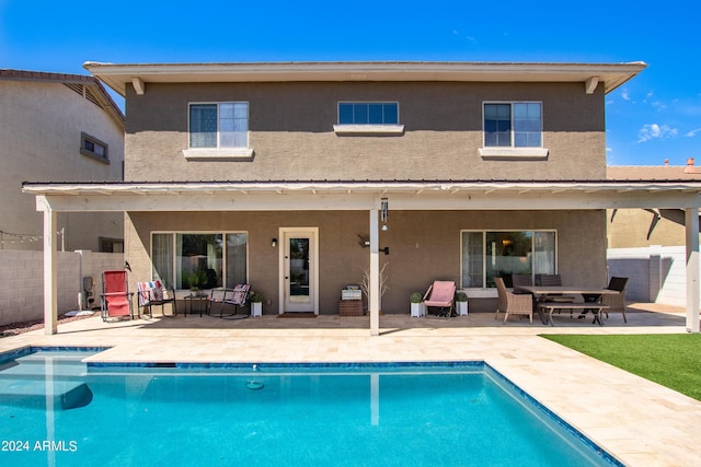 back of house with a fenced in pool, a patio area, fence, and stucco siding