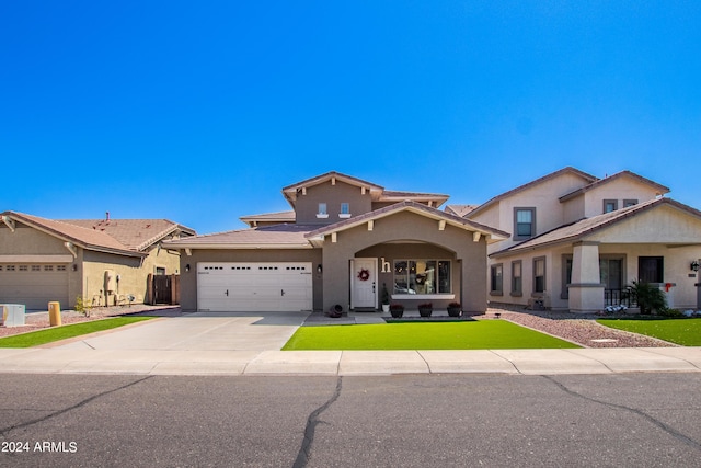 view of front of house featuring stucco siding, an attached garage, concrete driveway, and a front lawn