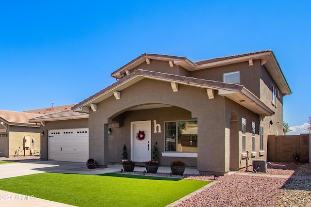 view of front of home featuring a tiled roof, stucco siding, an attached garage, and driveway