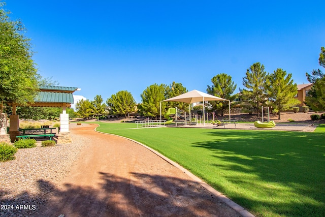 surrounding community with a yard and a playground