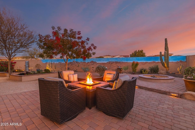 patio terrace at dusk with an outdoor fire pit