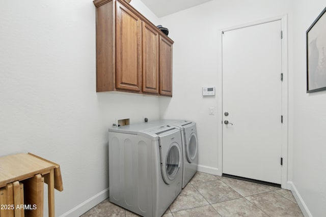 laundry area with cabinets, light tile patterned floors, and independent washer and dryer