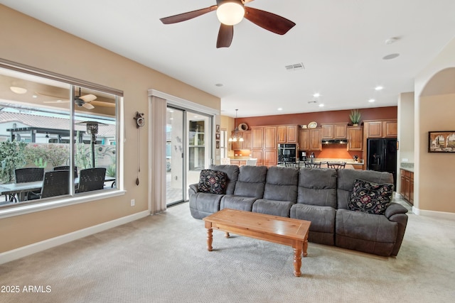 living room with light carpet and ceiling fan