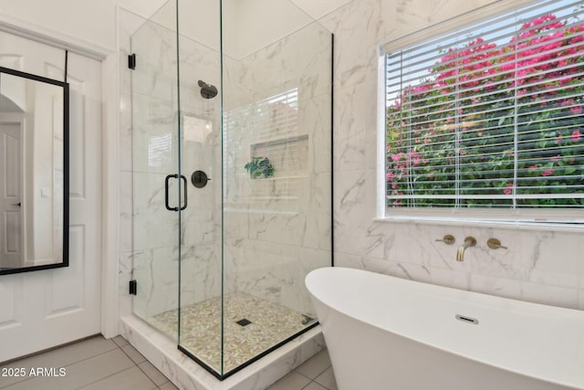 1070 S Amber St, Chandler, AZ 85286 - bathroom featuring healthy amount of natural light, a marble finish shower, tile patterned flooring, a soaking tub, and tile walls