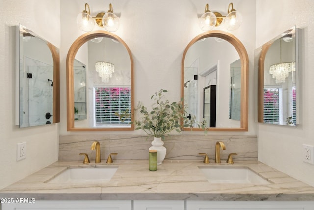 1070 S Amber St, Chandler, AZ 85286 - full bath featuring a chandelier, double vanity, an enclosed shower, and tasteful backsplash