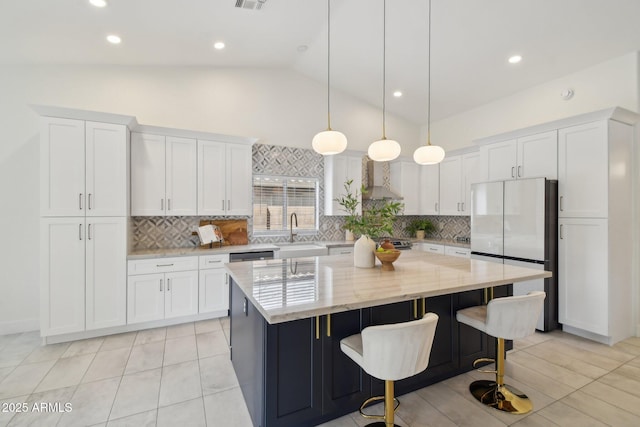 1070 S Amber St, Chandler, AZ 85286 - kitchen featuring freestanding refrigerator, a sink, white cabinets, vaulted ceiling, and recessed lighting