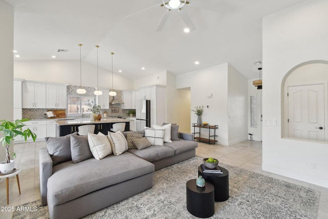 1070 S Amber St, Chandler, AZ 85286 - living room with a ceiling fan, light tile patterned flooring, high vaulted ceiling, baseboards, and recessed lighting