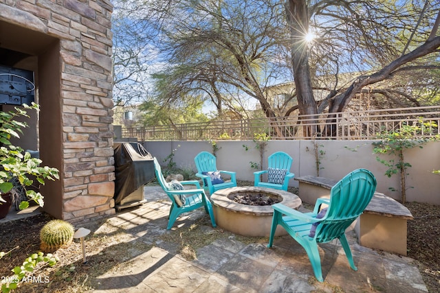 view of patio / terrace with a fire pit and a grill