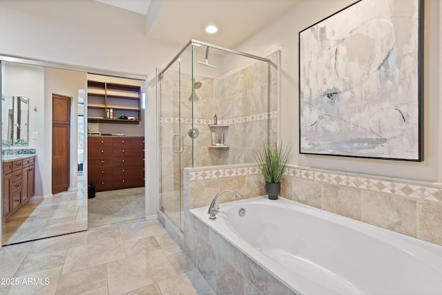 bathroom featuring separate shower and tub and vanity