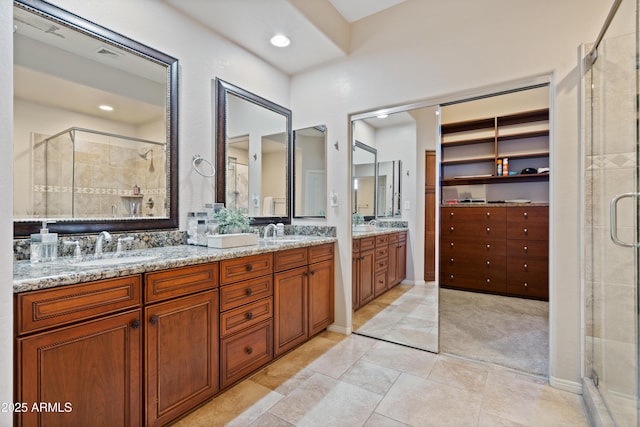 bathroom with vanity, tile patterned floors, and a shower with shower door