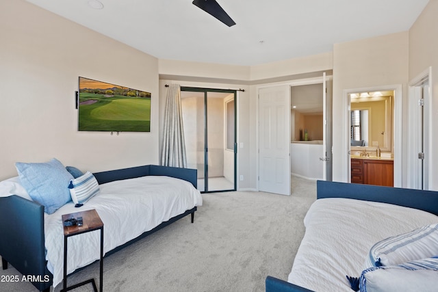 carpeted bedroom featuring ensuite bath and ceiling fan