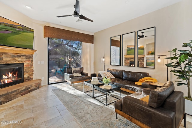 living room with a fireplace and ceiling fan