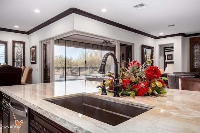 kitchen featuring sink, crown molding, and plenty of natural light