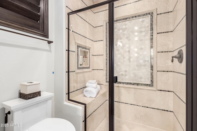 bathroom featuring toilet and an enclosed shower