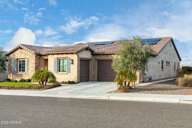 view of front of house featuring a garage and solar panels