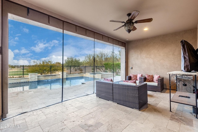 unfurnished sunroom featuring ceiling fan