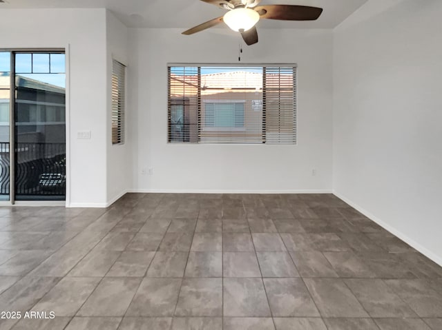 unfurnished room featuring baseboards, a healthy amount of sunlight, and ceiling fan