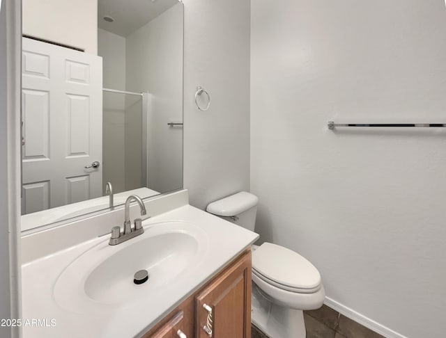 bathroom featuring tile patterned floors, toilet, baseboards, and vanity