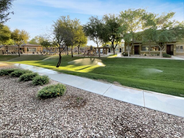 view of property's community featuring a yard