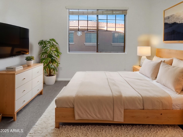 carpeted bedroom featuring baseboards