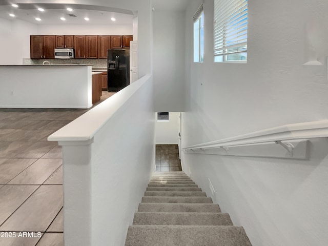 stairs with tile patterned flooring, visible vents, and recessed lighting