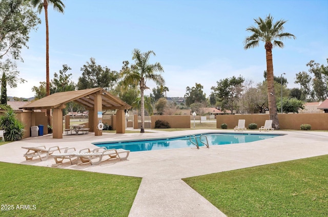 community pool with a gazebo, fence, a lawn, and a patio area