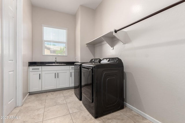 16860 W Soft Wind Dr, Surprise, AZ 85387 - laundry area with washing machine and clothes dryer, cabinet space, light tile patterned floors, and baseboards