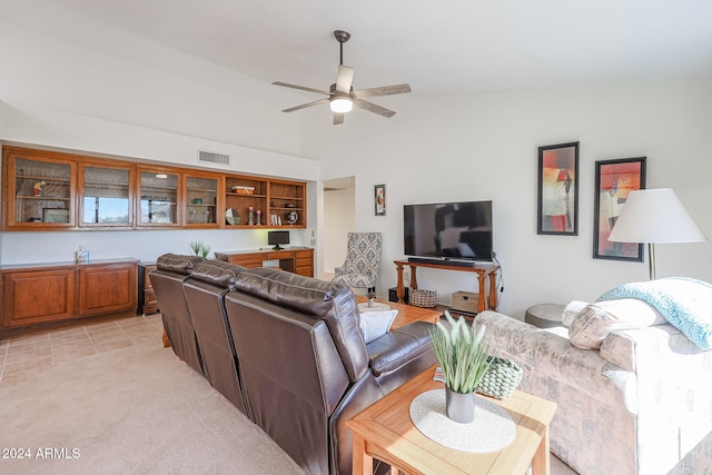 tiled living room with lofted ceiling and ceiling fan