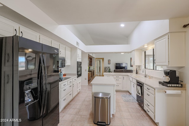 kitchen featuring black appliances, a kitchen island, sink, white cabinets, and kitchen peninsula