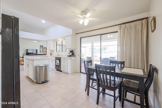 dining area with sink, ceiling fan, light tile patterned floors, and vaulted ceiling