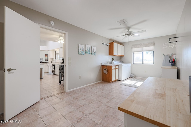 kitchen with black dishwasher, light tile patterned floors, and ceiling fan