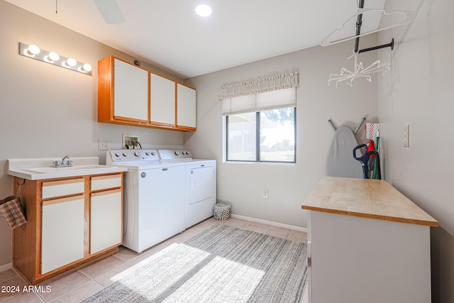 laundry area with cabinets, sink, ceiling fan, light tile patterned floors, and independent washer and dryer