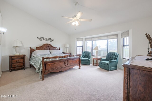 bedroom featuring high vaulted ceiling, light colored carpet, multiple windows, and ceiling fan