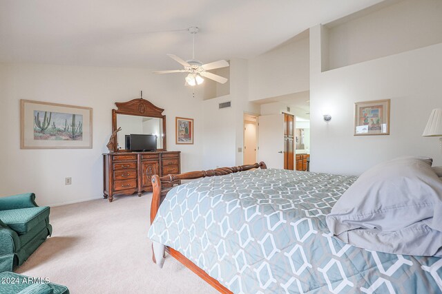 carpeted bedroom with connected bathroom, high vaulted ceiling, and ceiling fan