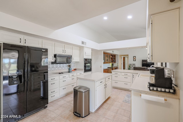 kitchen with white cabinets, kitchen peninsula, black appliances, and a center island