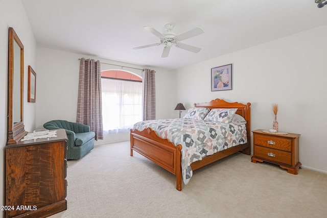 bedroom with light colored carpet and ceiling fan