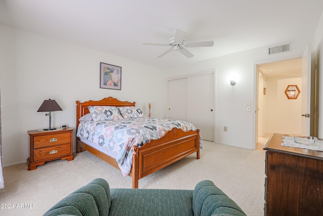 carpeted bedroom featuring a closet and ceiling fan