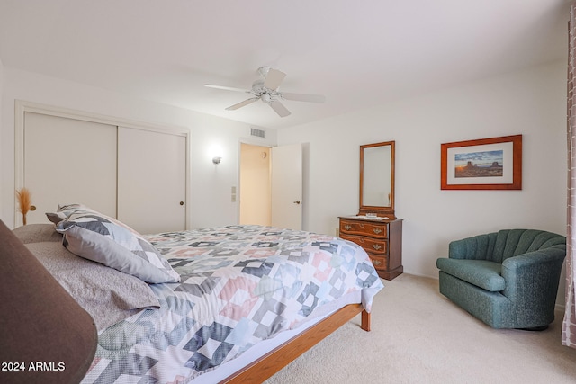 carpeted bedroom featuring ceiling fan and a closet