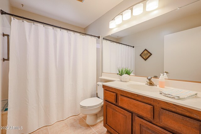 bathroom with vanity, tile patterned flooring, and toilet