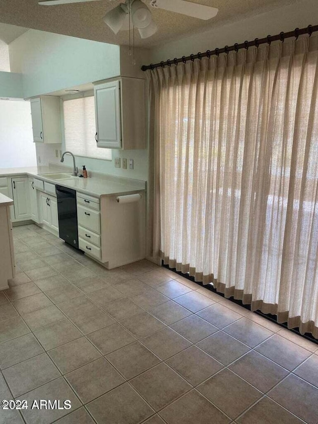 kitchen with dishwasher, white cabinetry, sink, and a textured ceiling