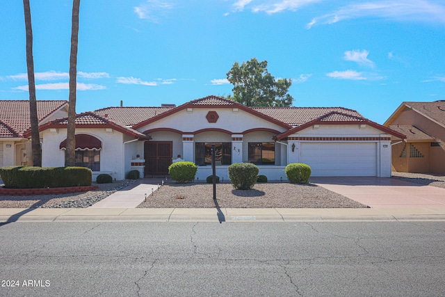 mediterranean / spanish-style home with a garage