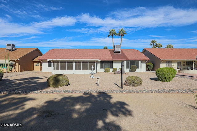 ranch-style home with a sunroom and cooling unit