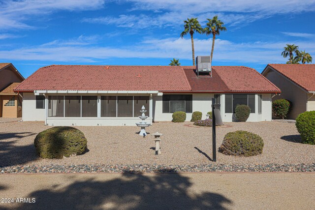 view of front of property with a sunroom and central AC