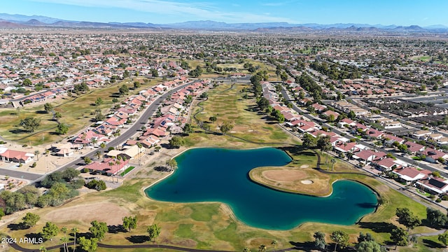 birds eye view of property with a water and mountain view