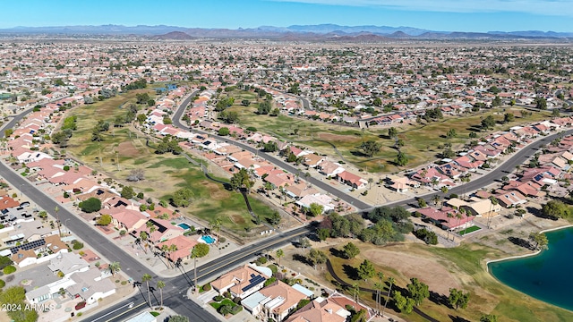 birds eye view of property with a water and mountain view