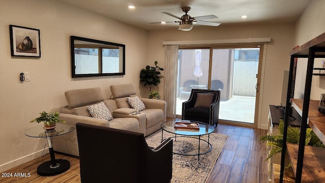 living room with ceiling fan and wood-type flooring