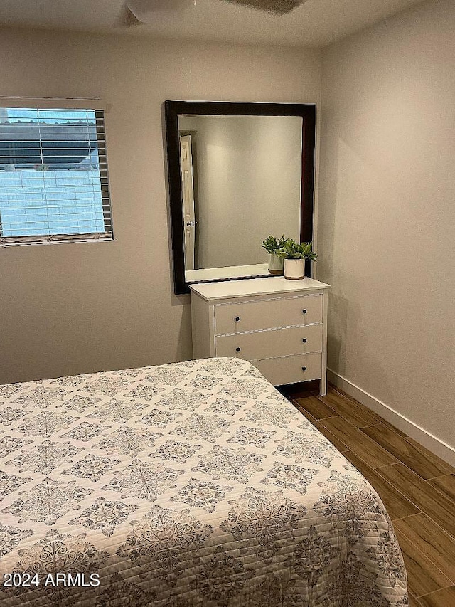 bedroom with ceiling fan and dark wood-type flooring