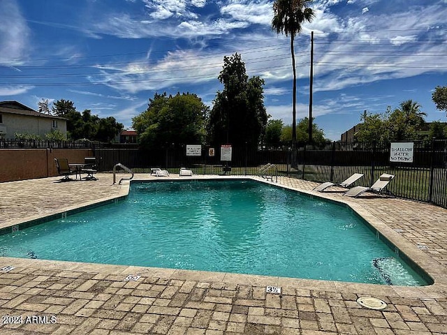 view of swimming pool featuring a patio area